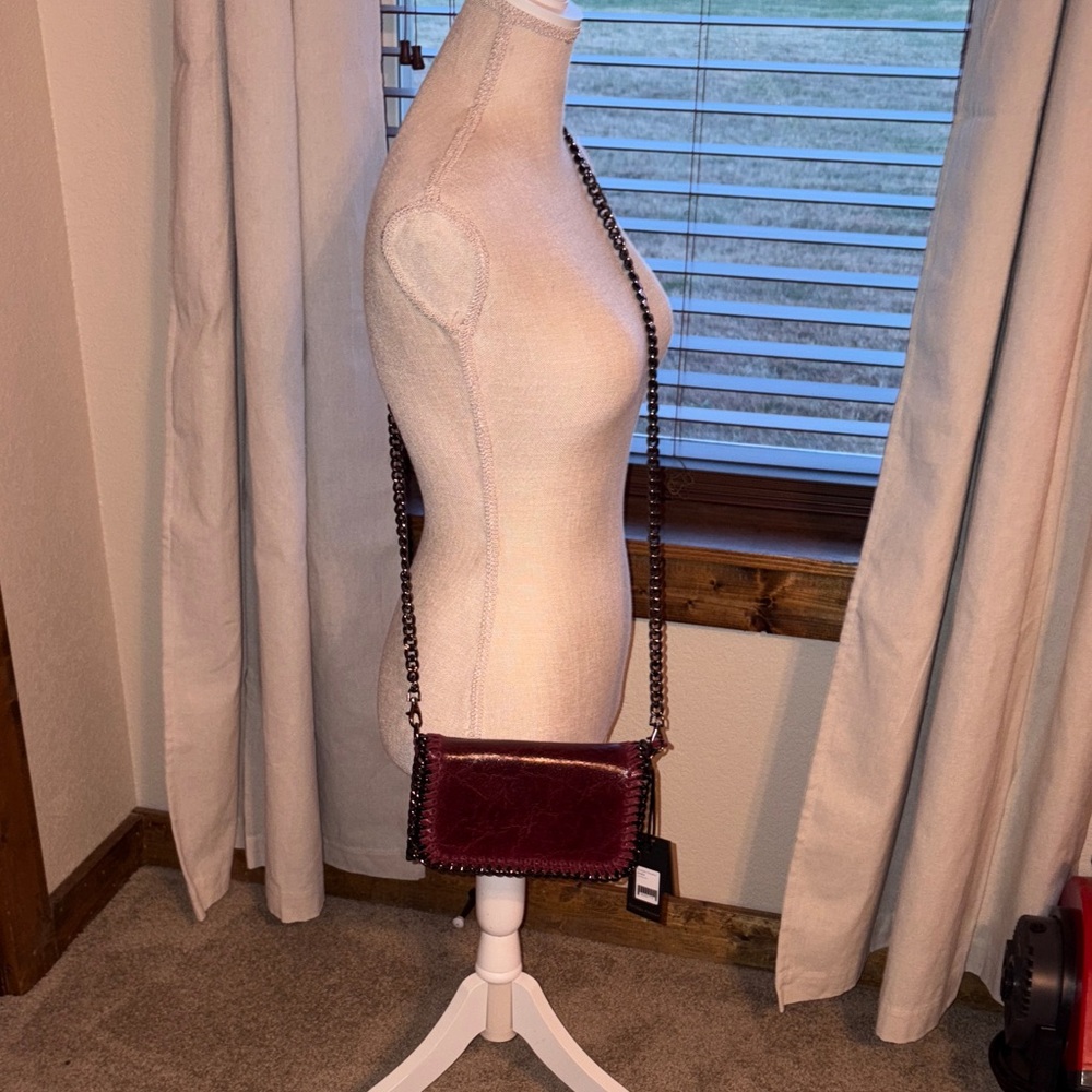 German Fuentes burgandy crossbody / clutch bag has unique metal chain for strap.